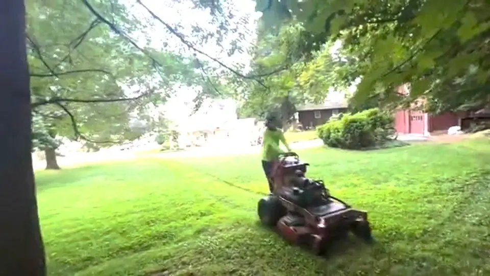 pro landscaper crew volunteers to assist elderly homebound veteran gentleman with free lawn service with commercial mowers