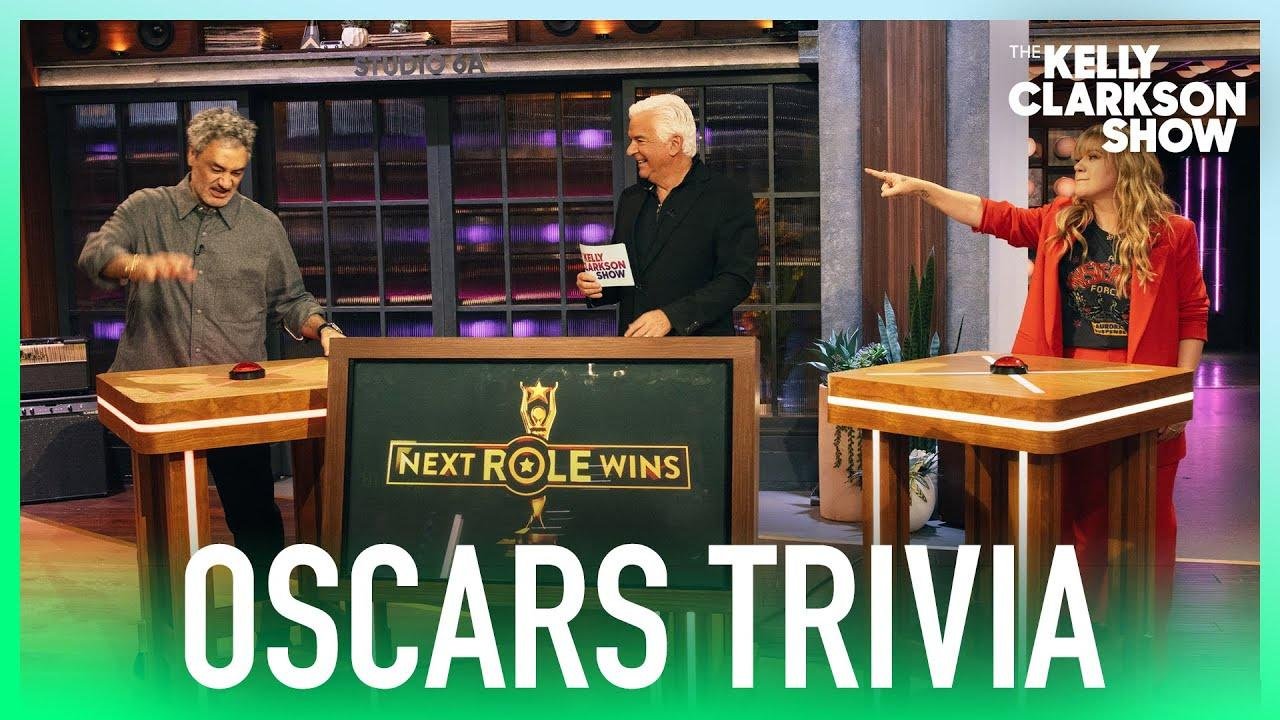 Taika Waititi & Kelly Clarkson Get 'Fiercely Competitive' In Oscars Trivia Hosted By John O'Hurley
