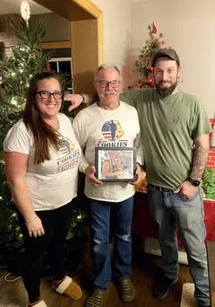 Santina's family continues her legacy: her daughter, Taylor Dubord, her husband, Steve Flynn, and her son, Justin Flynn. (Courtesy of Cookies for the Troops LLC)