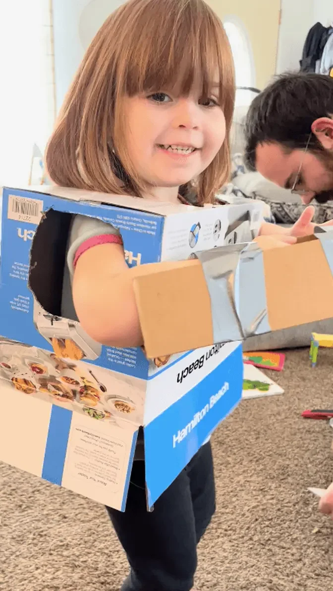 Mr. Farrell helps his kids to make robot outfits out of cardboard boxes. (Courtesy of Avery Farrell)