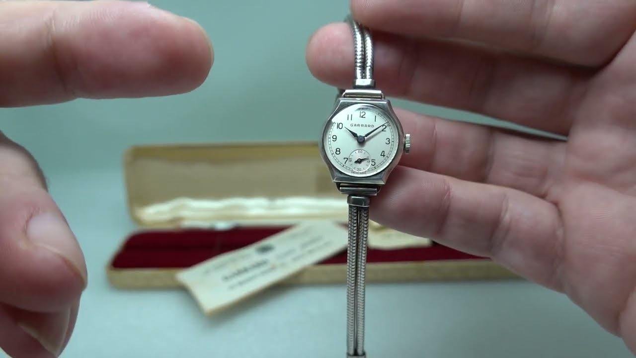 1964 Ladies sterling silver Garrard presentation watch with box and some papers.